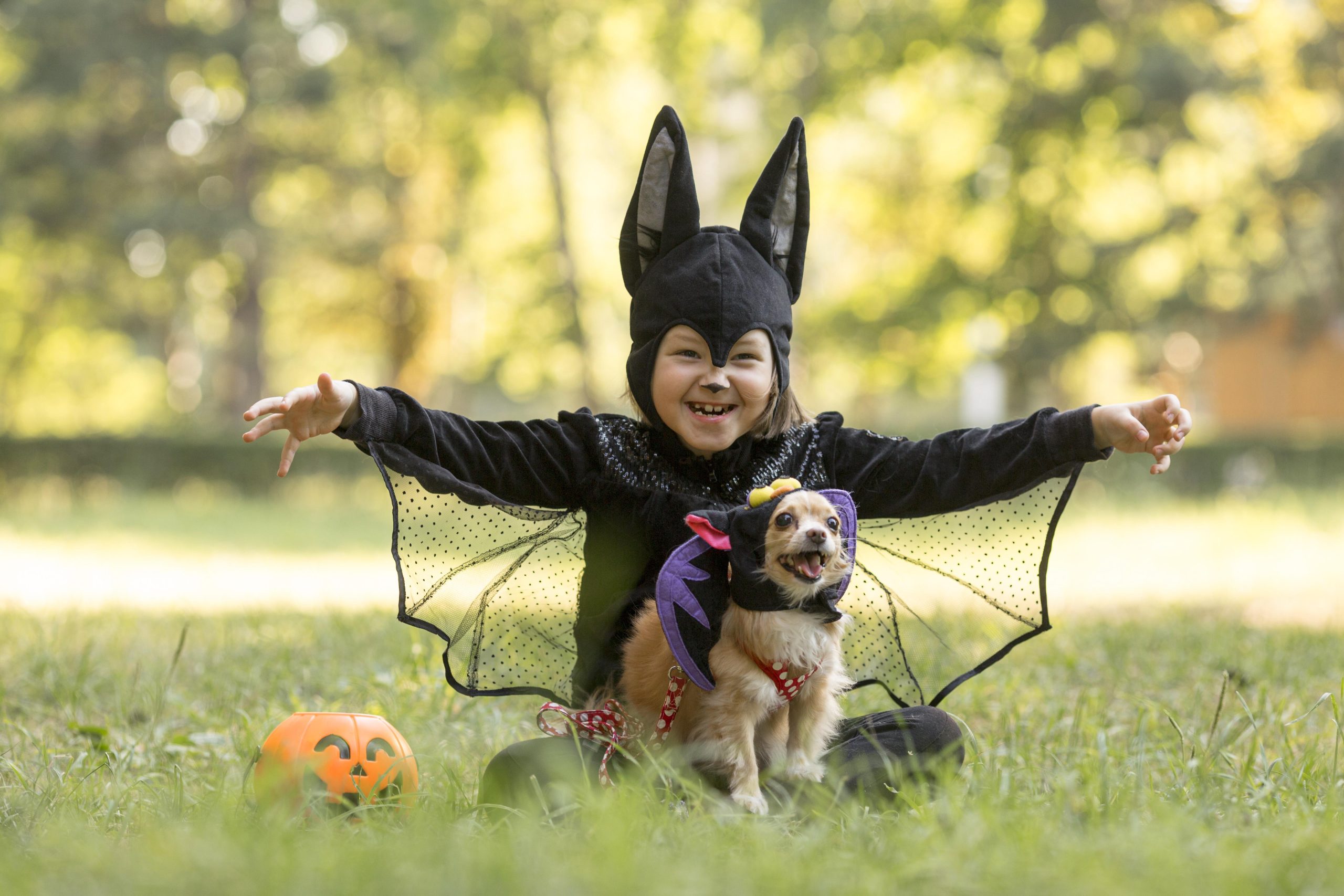 long-shot-little-boy-bat-costume Boy dressed as a bat with a dog in a costume